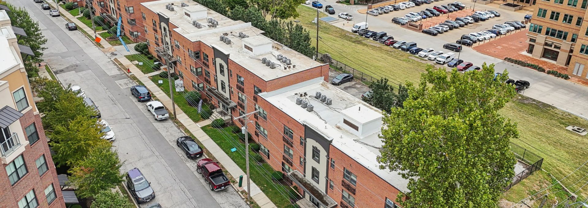 an aerial view of a city street with apartment buildings at The Broadway 46 Apartments
