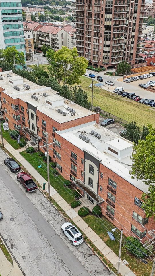 an aerial view of a city street with apartment buildings at The Broadway 46 Apartments